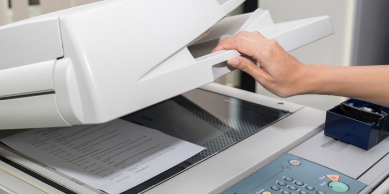 Hand operating a photocopier machine